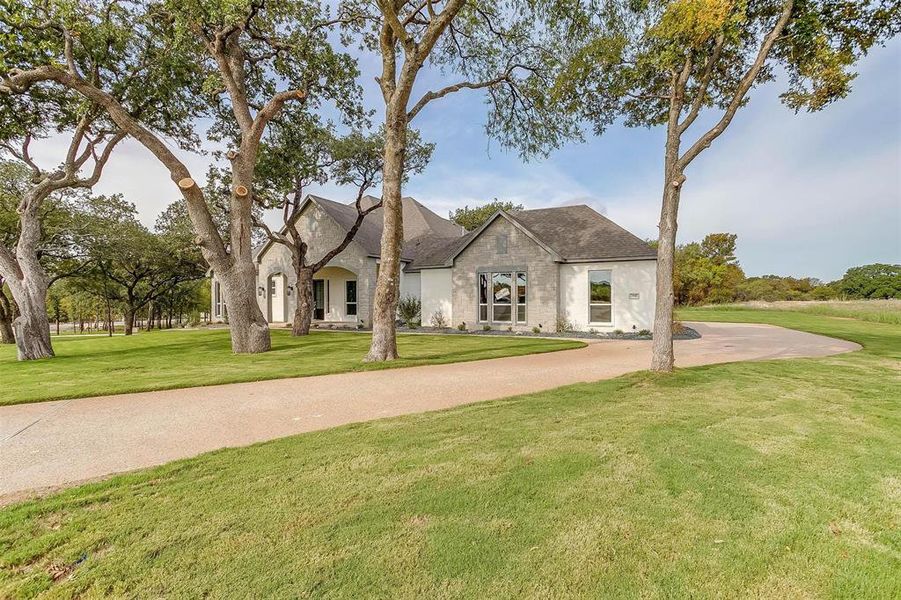 Front exterior of a new home in Woodland Meadows, Fort Worth, TX, highlighting curb appeal (Image 24). Front exterior of a new home in Woodland Meadows, Fort Worth, TX, highlighting curb appeal (Image 24).