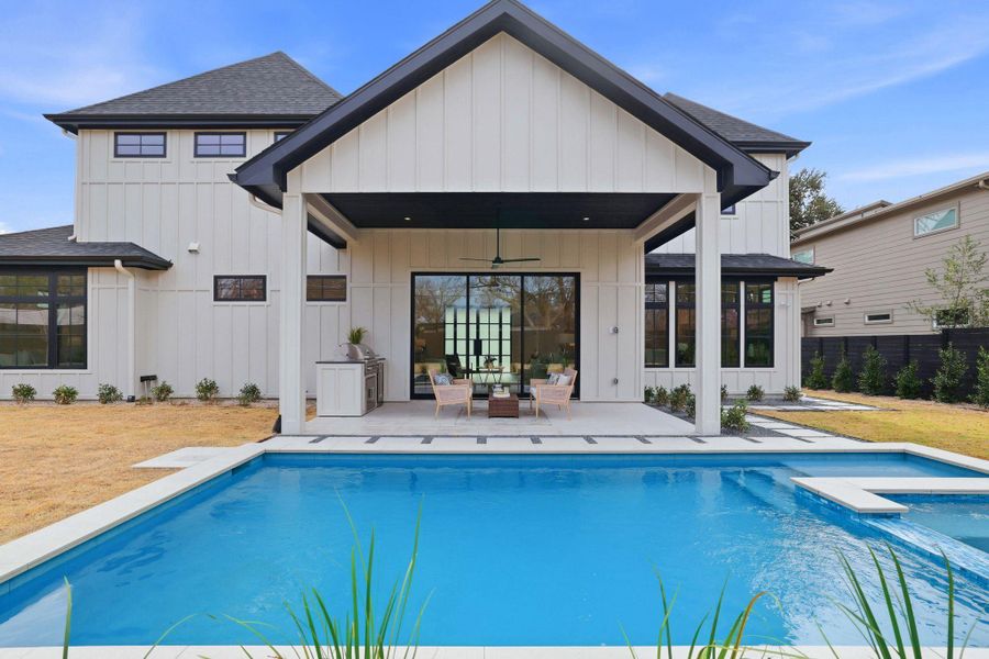 Back of house featuring ceiling fan, a patio area, board and batten siding, a shingled roof, and outdoor furniture