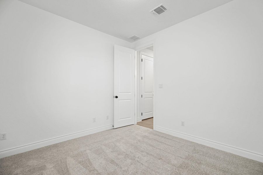 Carpeted empty room featuring baseboards