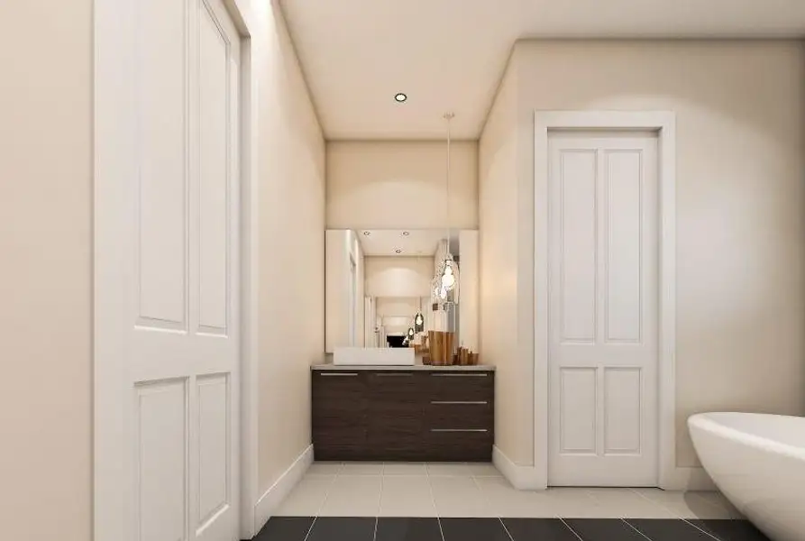 Bathroom featuring vanity, a soaking tub, baseboards, and tile patterned flooring