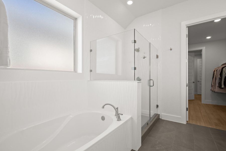Full bathroom with a bath, a stall shower, recessed lighting, and dark tile patterned floors