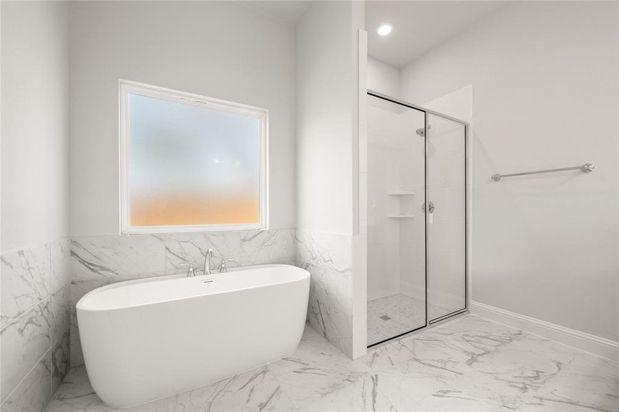 Full bathroom featuring marble look tiles, a stall shower, and a soaking tub Full bathroom featuring marble look tiles, a stall shower, and a soaking tub