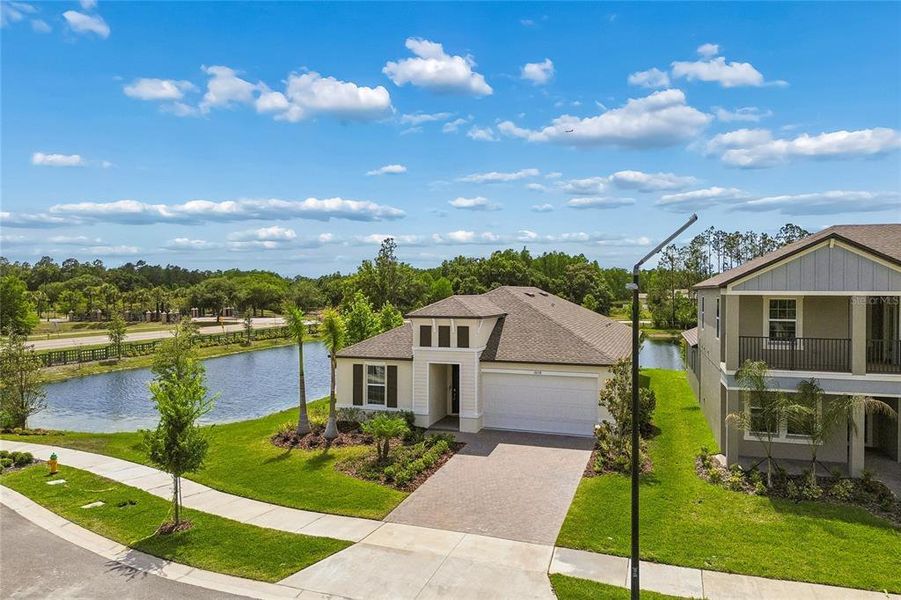 Front exterior of a new home in Pearl Estates, Lutz, FL, highlighting curb appeal (Image 27).