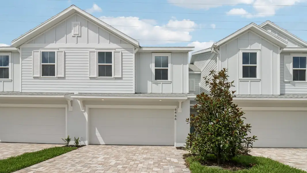 Front exterior of a new home in Cyrene at Harmony, St. Cloud, FL, highlighting curb appeal (Image 2). Front exterior of a new home in Cyrene at Harmony, St. Cloud, FL, highlighting curb appeal (Image 2).