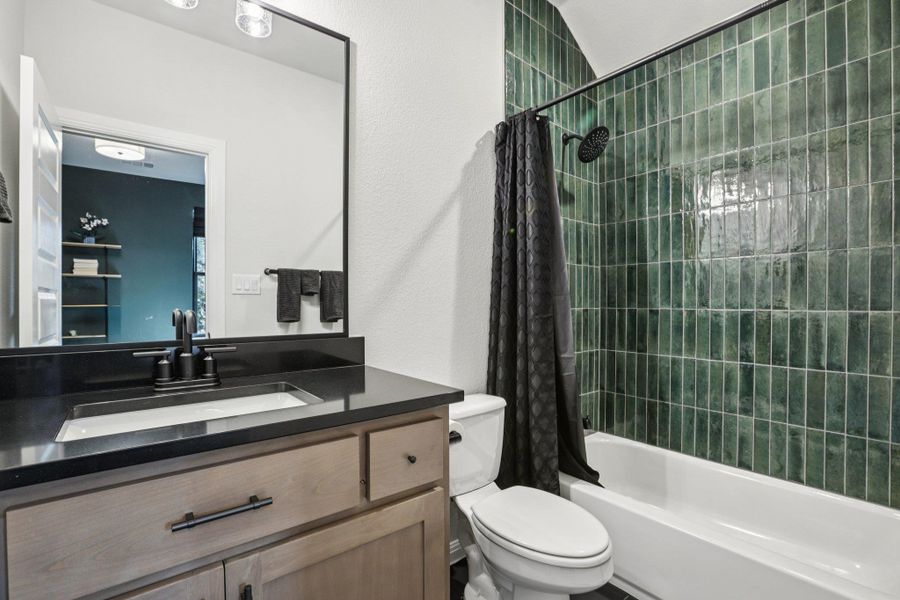 The second level hosts two additional secondary bedrooms, each with private en-suite baths.