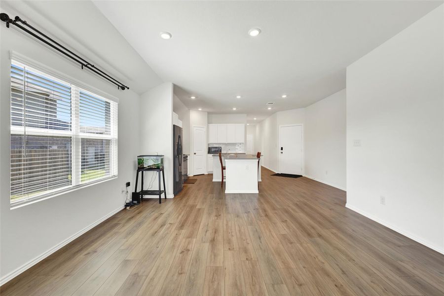 An open floorplan seamlessly connects the well-lit living area to the inviting kitchen, perfect for entertaining.