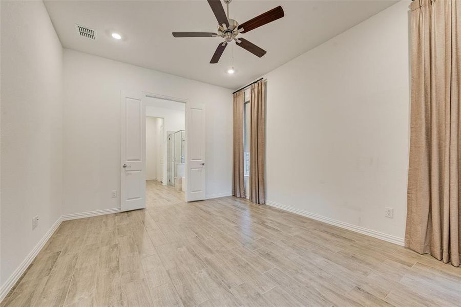 Unfurnished room featuring ceiling fan, light wood-style floors, and recessed lighting Unfurnished room featuring ceiling fan, light wood-style floors, and recessed lighting