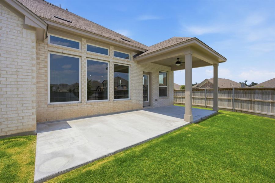 A spacious backyard with a generous patio offers an ideal setting for outdoor living.