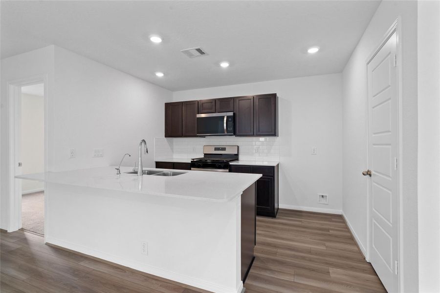 This spacious kitchen has it all—ample storage, generous counter space, and a layout that truly makes it the heart of the home.