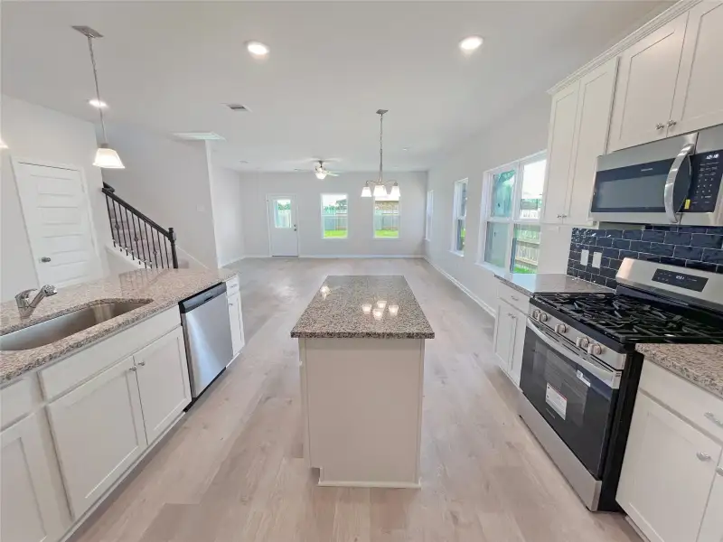 The Georgetown II- Kitchen into Family Room.Sample image for illustration; upgrades, options, and colors may vary.