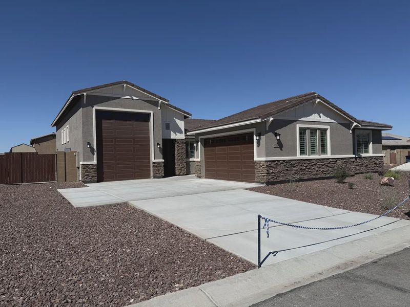 Front exterior of a new home in Las Barrancas, Yuma, AZ, highlighting curb appeal (Image 1). Front exterior of a new home in Las Barrancas, Yuma, AZ, highlighting curb appeal (Image 1).