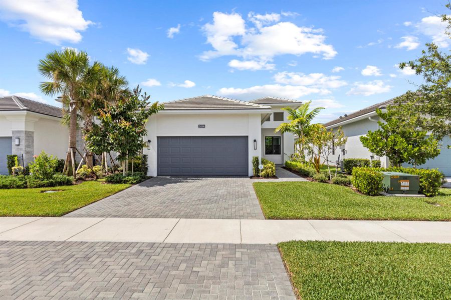 Front exterior of a new home in , The Acreage, FL, highlighting curb appeal (Image 24).