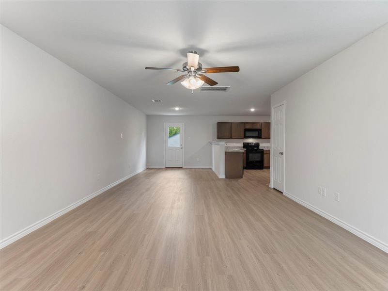 Spacious open-concept living and dining area with modern finishes, perfect for entertaining and family gatherings.