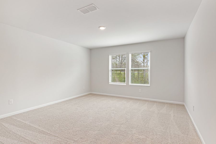 A room with a window and a carpet. A room with a window and a carpet.