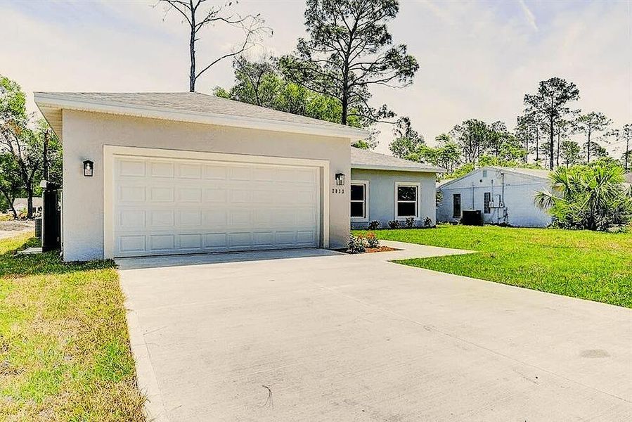 Front exterior of a new home in , Deland, FL, highlighting curb appeal (Image 2).