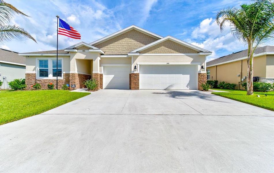 Front exterior of a new home in Archers Mill, Ormond Beach, FL, highlighting curb appeal (Image 24).