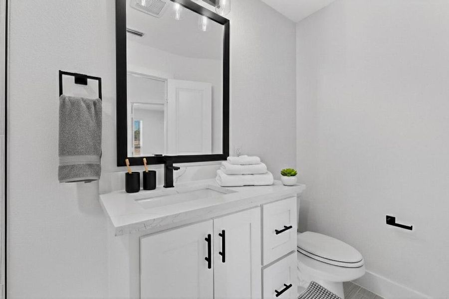Half bath with vanity and toilet