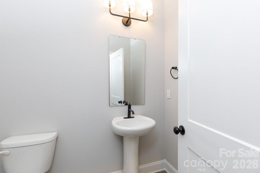 1/2 Bath located off the kitchen area. 1/2 Bath located off the kitchen area.