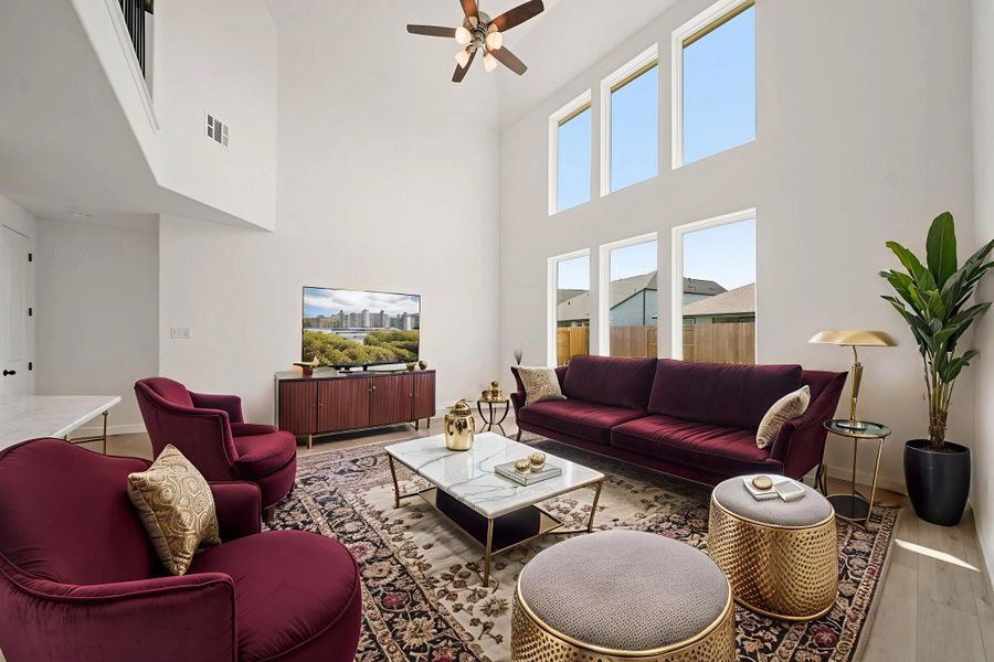 Two story family room. "Note: Sample product photo. Actual exterior and interior selections may vary by homesite. Photo may be virtually staged"