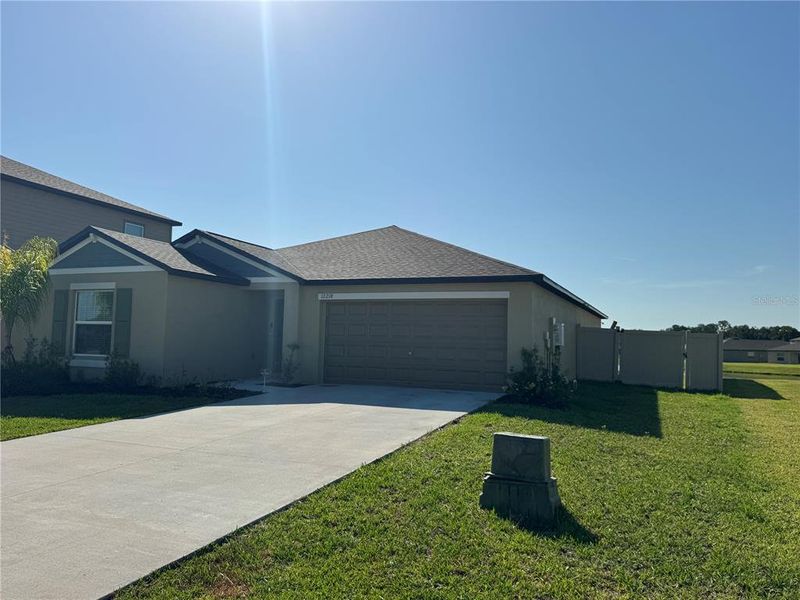 Front exterior of a new home in Prosperity Lakes, Parrish, FL, highlighting curb appeal (Image 20).