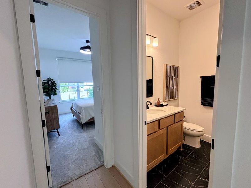 Hallway leading to a bedroom on the left and a bathroom on the right.