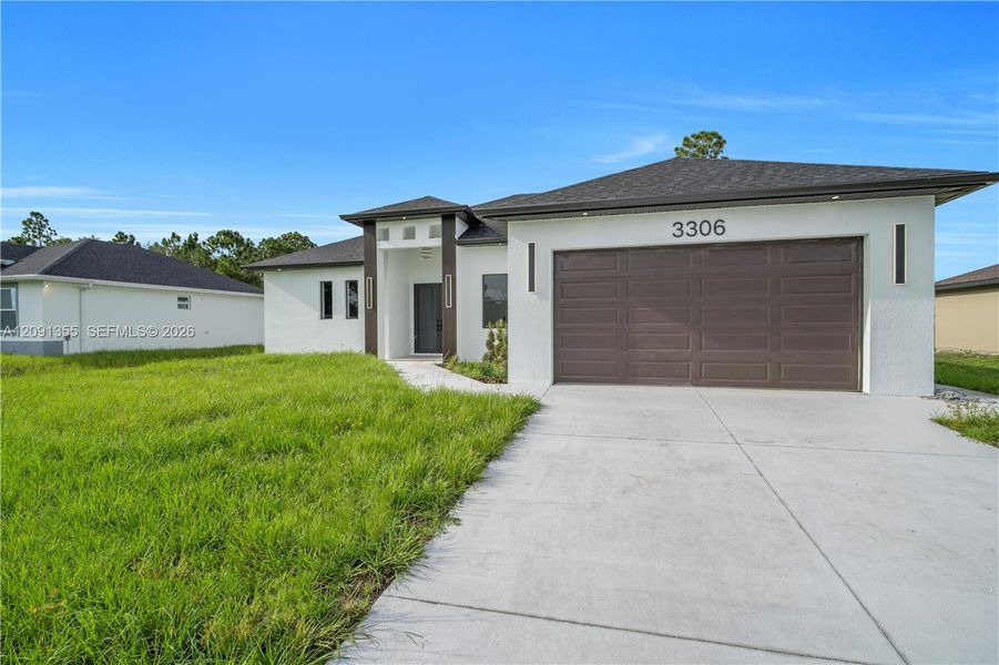 Front exterior of a new home in , Lehigh Acres, FL, highlighting curb appeal (Image 25). Front exterior of a new home in , Lehigh Acres, FL, highlighting curb appeal (Image 25).