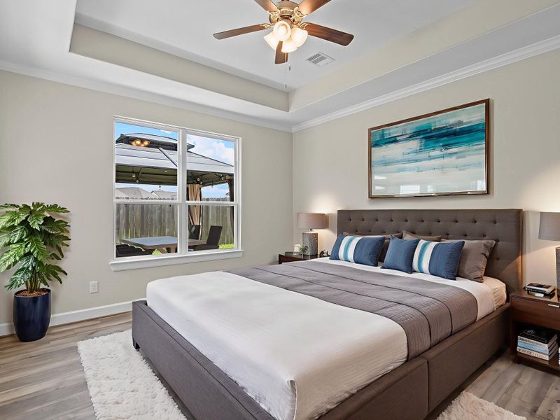 A serene owner’s retreat, the spacious primary bedroom delivers comfort and tranquility with ample room to unwind at the end of the day. Image depicts home as-is virtually staged.