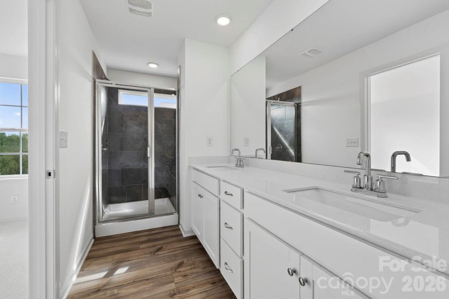 Beautiful owners bath with tiled shower and bench seat