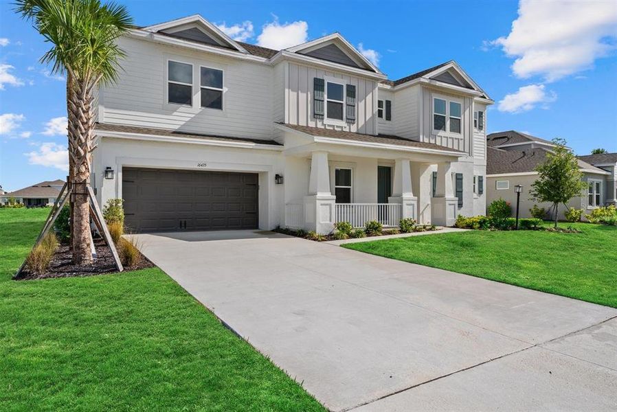 Front exterior of a new home in Park East at Azario, Bradenton, FL, highlighting curb appeal (Image 26). Front exterior of a new home in Park East at Azario, Bradenton, FL, highlighting curb appeal (Image 26).