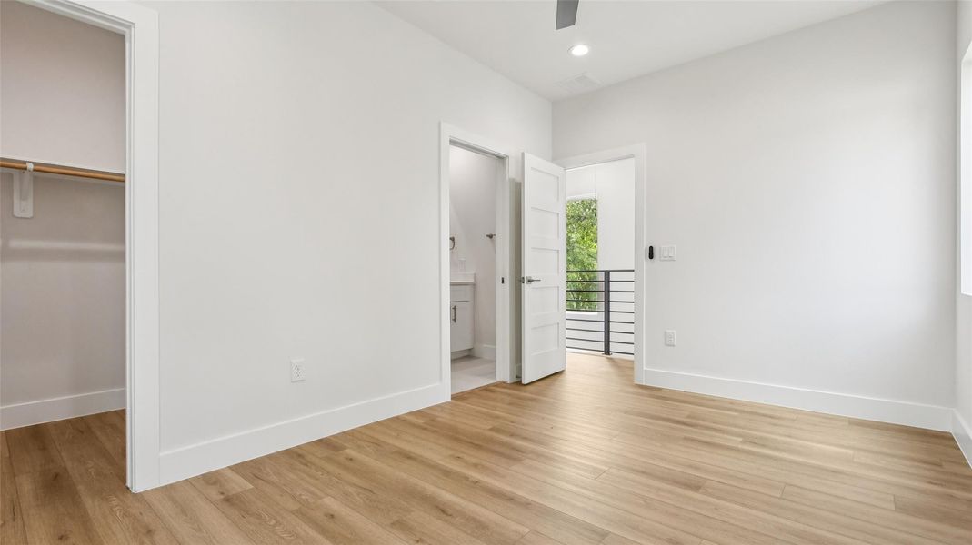 Unfurnished bedroom with light wood-style flooring, a spacious closet, a ceiling fan, and recessed lighting Unfurnished bedroom with light wood-style flooring, a spacious closet, a ceiling fan, and recessed lighting