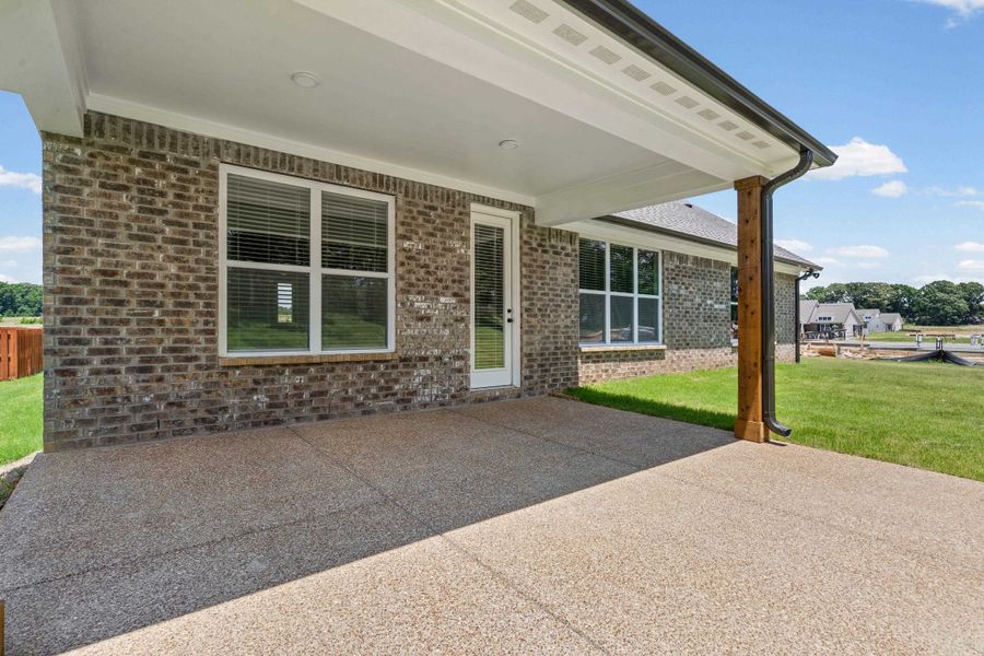 Covered outdoor patio featuring an exposed aggregate concrete surface Covered outdoor patio featuring an exposed aggregate concrete surface