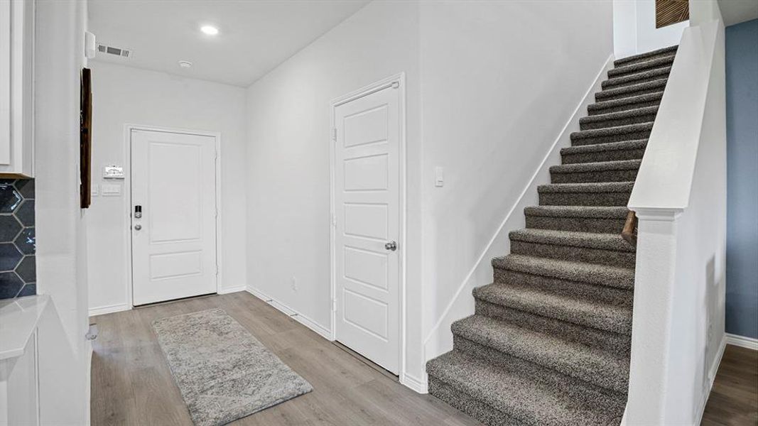 Entryway featuring light wood-style flooring and recessed lighting