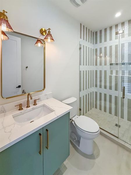 Full bathroom with vanity, light tile patterned floors, and a shower stall Full bathroom with vanity, light tile patterned floors, and a shower stall