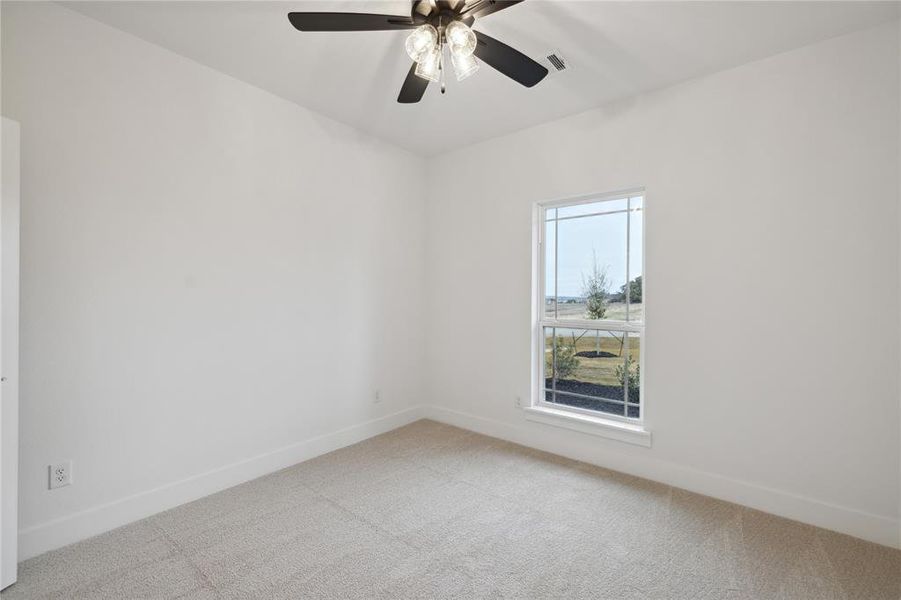 Spare room with light carpet and ceiling fan