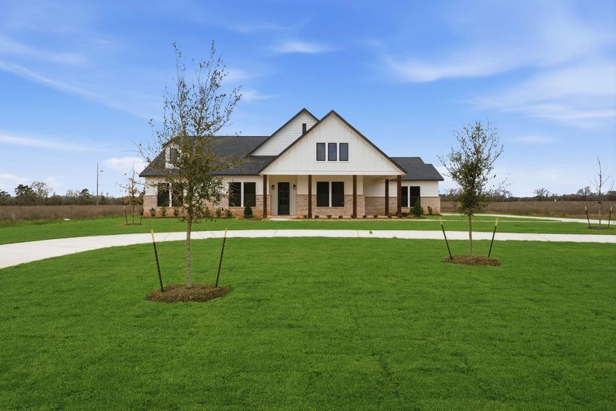 Front exterior of a new home in High Meadow Estates, New Waverly, TX, highlighting curb appeal (Image 28).