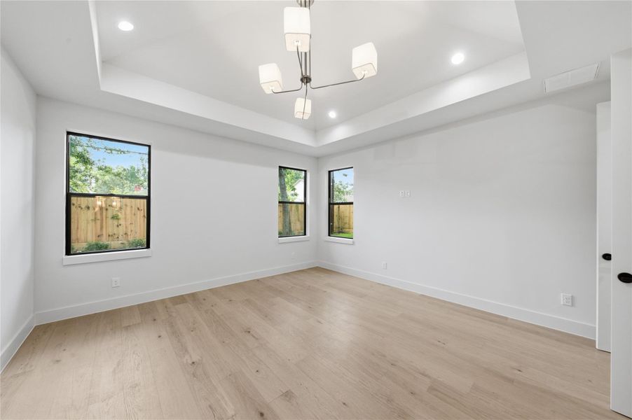 This elegant primary bedroom offers the perfect blend of comfort and sophistication, creating a true private retreat.