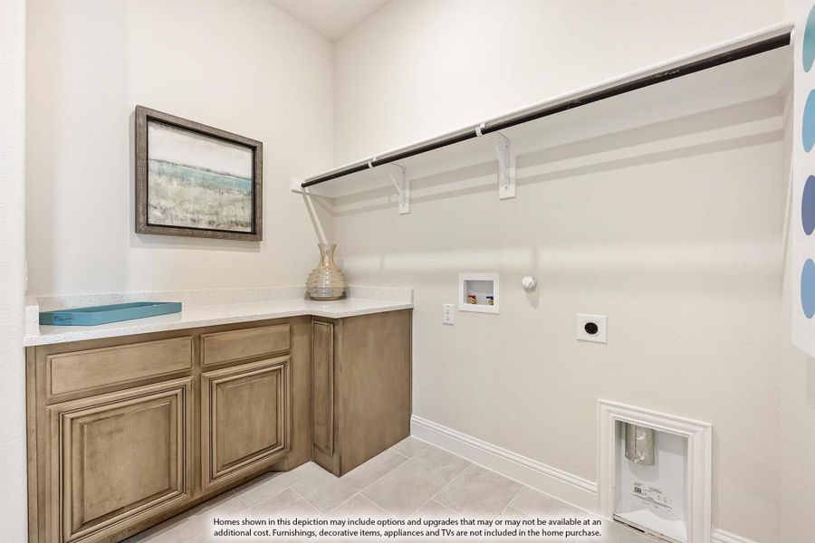 Laundry room with wood cabinets, white countertop, upper shelf, and hanging rod on tile floor Laundry room with wood cabinets, white countertop, upper shelf, and hanging rod on tile floor