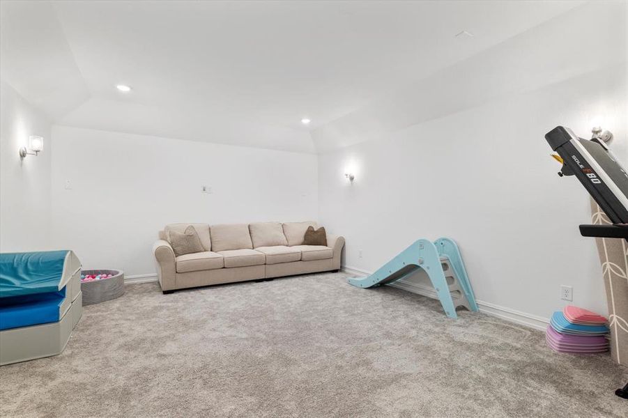 Unfurnished living room featuring recessed lighting, carpet flooring, and lofted ceiling