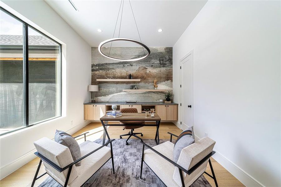 Office area with recessed lighting, light wood-type flooring, and an accent wall