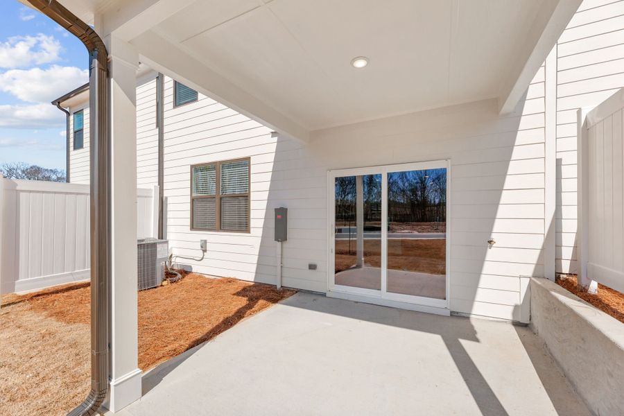 A white house with a large glass door.