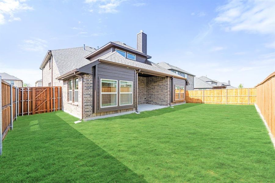 Exterior details and patio area of a home in Woodstone, Providence Village (Image 25).