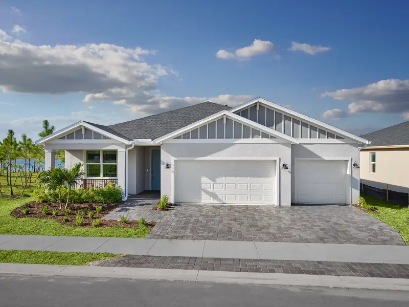 Front exterior of a new home in Hampton Park - Signature Series, Vero Beach, FL, highlighting curb appeal (Image 1).
