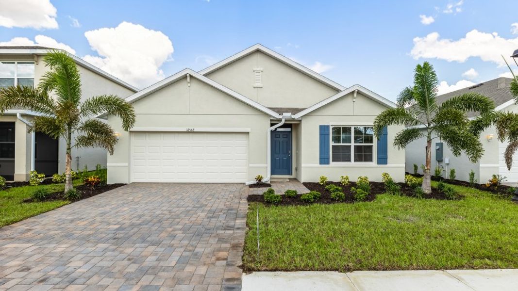 Front exterior of a new home in Coral Bay - Express & Tradition, North Fort Myers, FL, highlighting curb appeal (Image 1).
