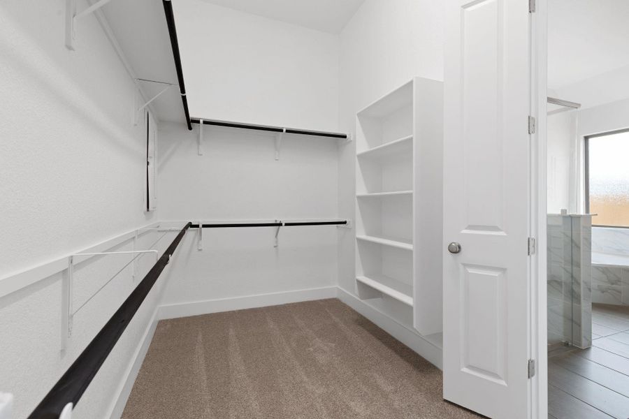 Walk-in closet in Primary Bedroom Walk-in closet in Primary Bedroom