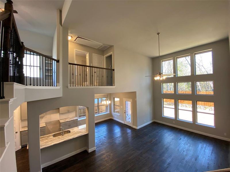 View from above the family room with wrought iron spindles, rich hardwood floors, and a wall of windows! View from above the family room with wrought iron spindles, rich hardwood floors, and a wall of windows!