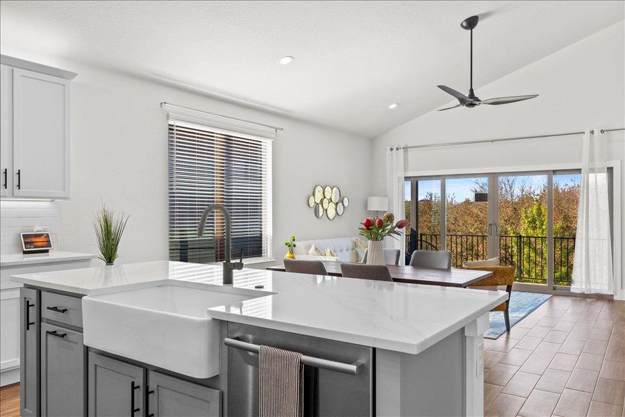 Kitchen with stainless steel dishwasher, light wood finished floors, recessed lighting, a ceiling fan, and light stone countertops