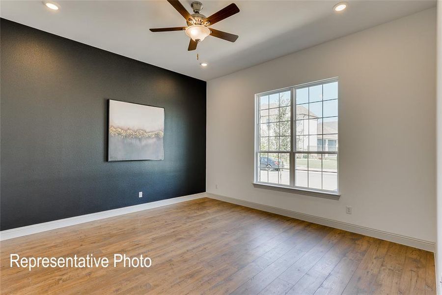 Empty room featuring ceiling fan and light hardwood / wood-style floors