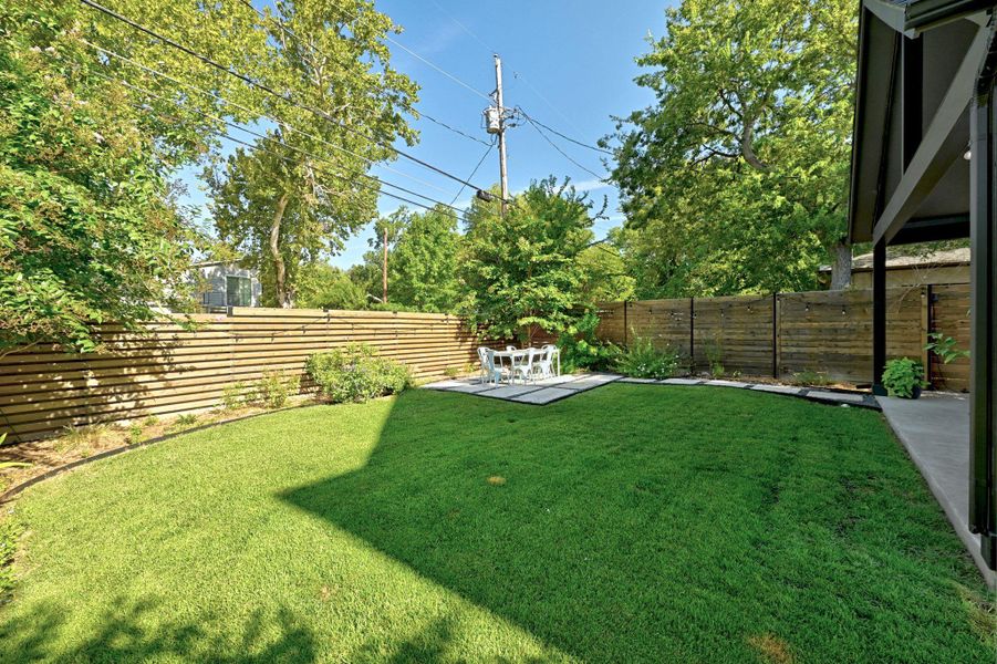 Yard view with covered and uncovered patio areas. Yard view with covered and uncovered patio areas.
