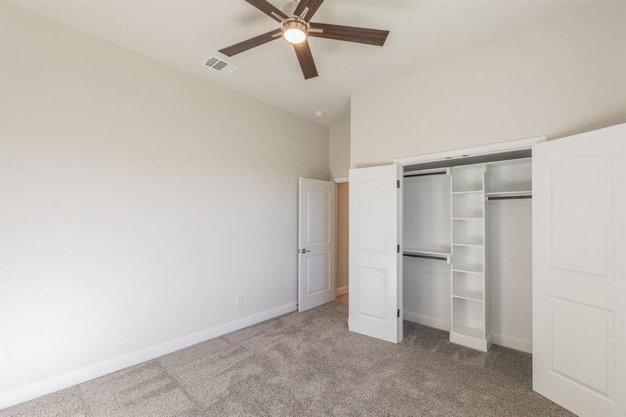Unfurnished bedroom featuring carpet, a closet, and ceiling fan Unfurnished bedroom featuring carpet, a closet, and ceiling fan