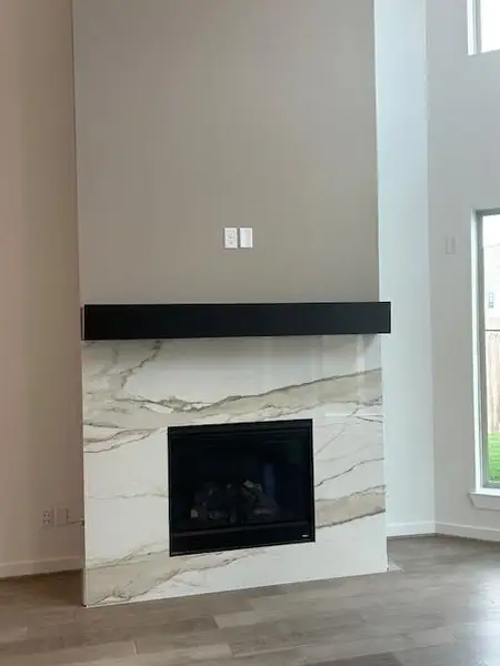 Gas fireplace with a floating mantel is a focal point in the family room.